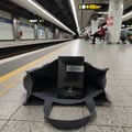 Maison Alhambra Yeah! by Maison Alhambra 100ml EDP Men — A dark blue perfume box with 'YEAH!' written in white, placed inside an open grey tote bag on a subway platform.
