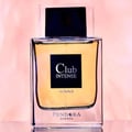 Pendora Club Intense 100ml EDP Men Paris Corner Pendora — Square glass bottle with golden liquid, black label with white text 'Club INTENSE HOMME', and a black cap, set against a soft pink background.