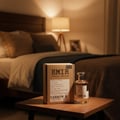 Paris Corner Rich Santal Emir by Paris Corner — Cardboard box and glass perfume bottle with gold cap on a wooden table, bedroom in background.