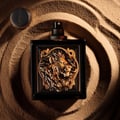 Rayhaan Rayhaan Lion Powerful for Man 100ml — Black perfume bottle with a gold lion emblem on a swirling sand background, with the cap to the left.