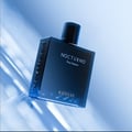 Rayhaan Nocturno by Rayhaan – 100 ml Eau de Parfum for Men, a dark blue glass bottle with "NOCTURNO Pour Homme" and "RAYHAAN" printed in white, set against a blurred blue background with light streaks.
