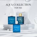 Rayhaan Pacific Perfume 100ml untuk Lelaki — Tiga botol minyak wangi kaca biru bercorak ombak, satu berpenutup emas, dipamerkan di atas batu putih bertekstur.