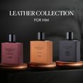 Rayhaan Rayhaan Leather Collection 100ml EDP – Corium, Dark Leather, Cordova. Botol minyak wangi balutan kulit maroon dengan penutup hitam, diletakkan di atas permukaan kayu bersama but koboi, tepi topi dan tali.