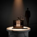 Rue Broca Pride Intense EDP Men — A dark glass perfume bottle with a white label reading 'PRIDE INTENSE' sits on a marble pedestal, with a silhouette of a man in a suit walking away in the background.