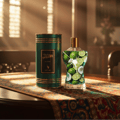 Volare Le Beau Gladiator Twilight — Green cylindrical box with gold trim and label, next to a clear glass perfume bottle filled with limes and coconut slices, on a patterned table runner.