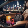 Golden Hour by Volare 100ml EDP for Her — Botol dan kotak minyak wangi di konsol tengah kereta dengan latar langit bandar pada waktu malam kelihatan di luar tingkap.