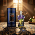 Volare Parfum Gladiator Twilight 100ml by Volare Man — Blue cylindrical packaging and a unique hourglass-shaped perfume bottle filled with lavender and citrus slices, surrounded by cardamom pods on a patterned tablecloth.
