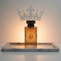 Zimaya Al Embratur Elixir by Zimaya 100ml EDP — Rectangular glass perfume bottle with ornate gold pattern and Arabic script, casting a crown shadow on a warm-toned wall, placed on a marble tray.