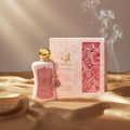 Zimaya Fatima by Zimaya 100ml Extrait de Parfum Women — Pink perfume bottle with gold cap and tassels, next to a pink box with roses, on a golden satin cloth with smoke wisps