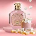 Zimaya Zukhruf Femme Pink by Zimaya 100ml EDP Women — Pink perfume bottle with gold accents, on a pink pedestal, surrounded by marshmallows and a mug of marshmallows.