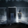 Zimaya Inekas Luna by Zimaya 100ml EDP Men — A glass perfume bottle and its black textured box sit on a marble surface with smoke effects.