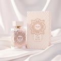 Zimaya Musk Is Great by Zimaya 100ml EDP Unisex — White perfume bottle with gold geometric accents and a white ribbed cap, next to its matching patterned box, set against a draped white satin background.