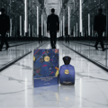 Zimaya Evolution by Zimaya 100ml EDP For Men — A blue perfume bottle and its matching box are displayed on a reflective marble surface, with a man in a suit walking away in a mirrored hallway.