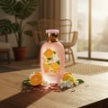 Zimaya Only You by Zimaya Perfume Elixir 100ML EDP — Pink perfume bottle with citrus and white flower design, surrounded by orange slices, lemon, and white blossoms on a wooden table.