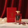 Bujairami Red Static by Bujairami Eau de Parfum 100ml — Red perfume bottle with gold cap next to its red box, set against a red draped background with scattered rose petals and sheer fabric.