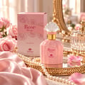 TADangel Rose Divine — Pink perfume bottle and box with roses, surrounded by pearls and pink silk, with a decorative mirror and crystal bottle in the background.