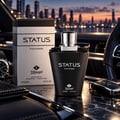 TADangel Status by TADangel 100ml EDP Lelaki — Botol dan kotak wangian hitam dengan aksen perak, diletakkan di atas permukaan marmar bersama kunci kereta dan jam tangan, latar belakang langit bandar senja.