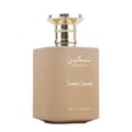 Paris Corner Taskeen Caramel Cascade 100ml — A light brown square perfume bottle with a gold cap, featuring gold Arabic script and text "TASKEEN", "Caramel Cascade", and "PARIS CORNER" | Paris Corner Taskeen Caramel Cascade 100ml — Botol minyak wangi segi empat berwarna coklat muda dengan penutup emas, menampilkan