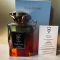 Bujairami Vanilla Dream Eau de Parfum — A glass perfume bottle with a gradient amber to clear liquid, a gold cap, and a black label. A light blue box and a product information card are behind it.