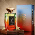 Bujairami Vanilla Dream Eau de Parfum — Gradient glass bottle with gold cap, displayed on a wooden stand with vanilla pods and flowers, next to its blue and orange gradient box.