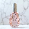 Ard Al Zaafaran Yara Eau De Parfum 50ml — A faceted glass perfume bottle with pink liquid and a silver cap, set against a marble background. | Ard Al Zaafaran Yara Eau De Parfum 50ml — Botol minyak wangi kaca berfaset dengan cecair merah jambu dan penutup perak, diletakkan di atas latar belakang marmar.